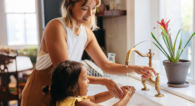 Mom washing child's hands